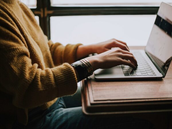 person sitting at a computer typing