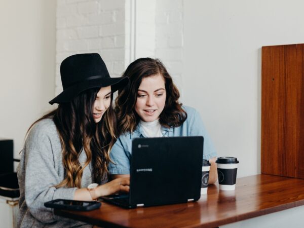 two girls on laptop recording a customer video